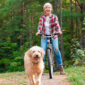 Woman cycling with dog - How not to have a heart attack - healthy living - diet & wellbeing - allaboutyou.com