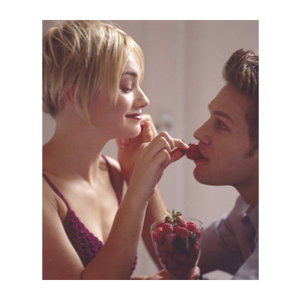 couple feeding each other strawberries