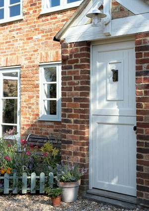 Exterior of a country house with a white wooden door - Winterproof your home - Homes - allaboutyou.com