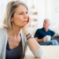 Woman looking sad with husband in background - Have you forgotten how to be intimate? - Diet&wellbeing - allaboutyou.com