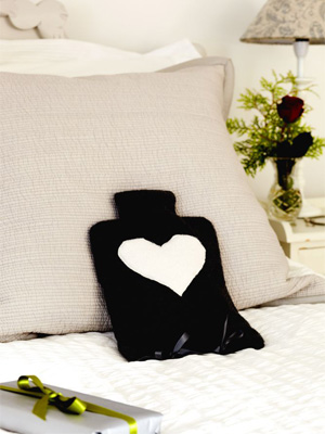 Fleece hot-water bottle cover with heart shaped pattern