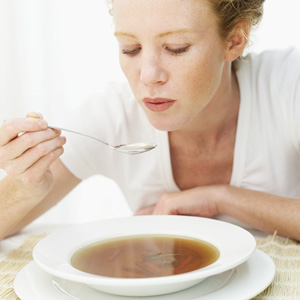 Woman eating soup - low calorie recipes - diet & wellbeing - allaboutyou.com