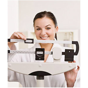 Woman on scales smiling - Find the diet to keep the weight off - diet plan - diet & wellbeing - allaboutyou.com