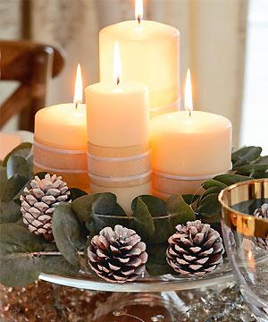 flower arranging candle and pine cone centrepiece