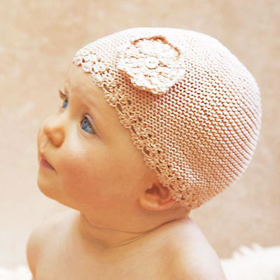 Baby in a knitted hat free knitting patter for a babies hat by Erika Knight craft ideas allaboutyou.com
