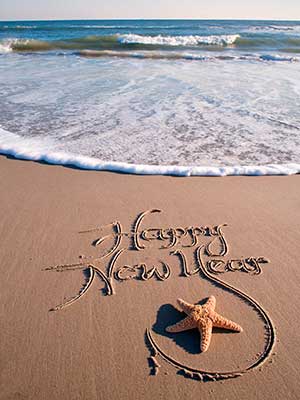 Happy New Year written in sand - New Year, new you: your healthy guide to 2015 - New Year resolutions - diet & wellbeing - allaboutyou.com