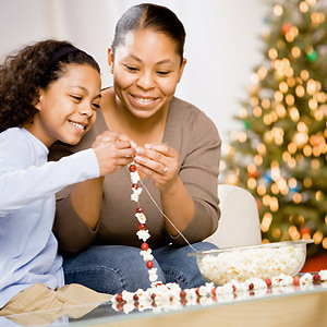 Getty - woman and child making Christmas popcorn and cranberry garland - Christmas craft - Craft - allaboutyou.com