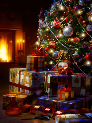 christmas tree and gifts beside fireplace