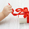 child's hand reaching for present - 30 Christmas gifts to make for babies and children - Craft - allaboutyou.com