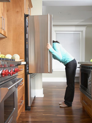 Woman looking in fridge - Crack the 5:2 diet and beat the bulge - Diet&wellbeing - allaboutyou.com