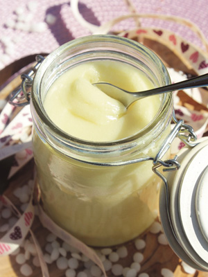 Glass jar filled with homemade coconut body balm, natural skincare from allaboutyou.com