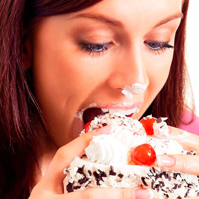 Woman scoffing cream cake - Ten ways to beat emotional eating - Healthy eating - Diet & wellbeing - allaboutyou.com
