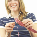 smiling woman knitting - knitting patterns - craft - allaboutyou.com